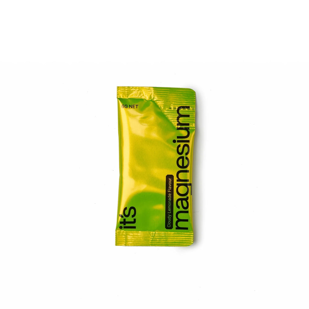 Green packet of magnesium supplement on a white background