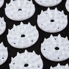 White circular objects with spike-like protrusions on a black background