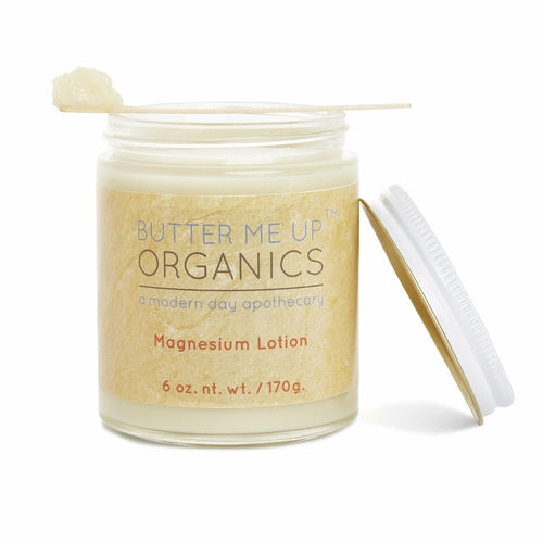 Butter Me Up Organics magnesium lotion jar with a wooden applicator on a white background