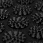 Close-up of textured circular objects with geometric patterns on a dark background
