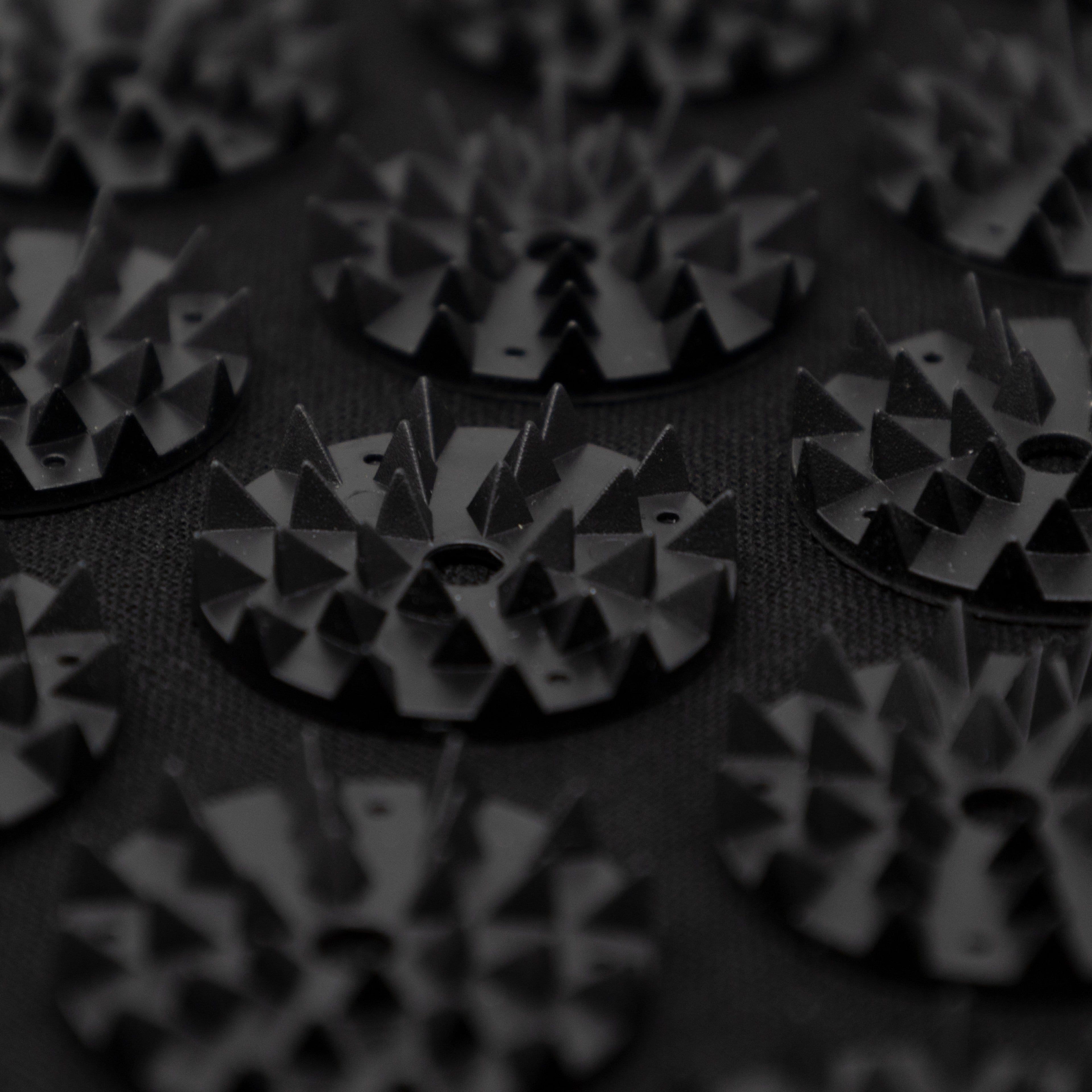 Close-up of textured circular objects with geometric patterns on a dark background
