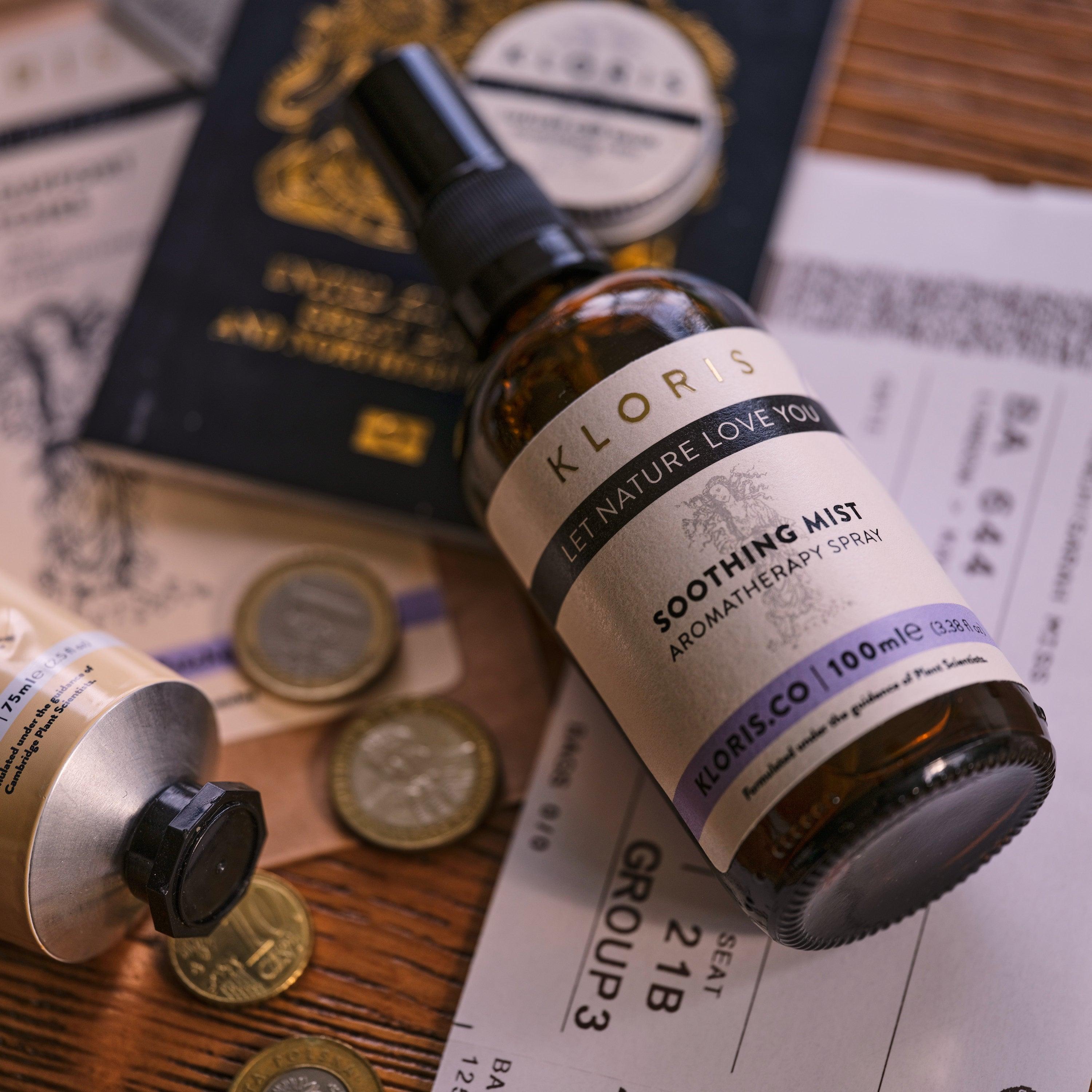 Kloris sooting mist bottle on a surface with coins and documents