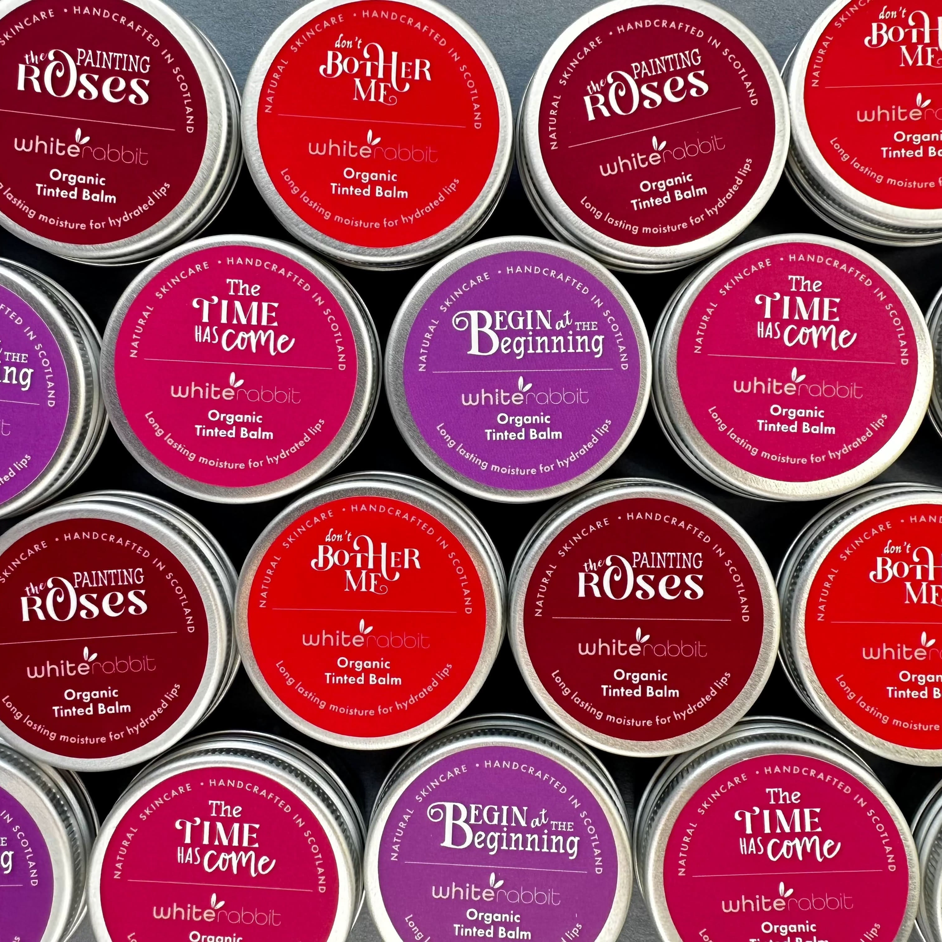 Collection of tins with various labels arranged in a pattern