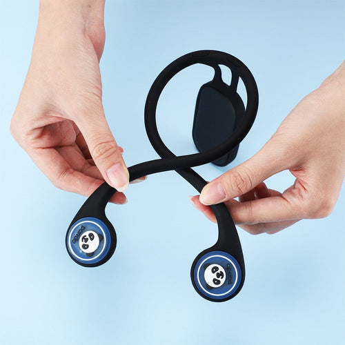 Black and blue fidget spinner held by two hands against a light blue background