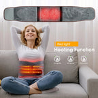 Woman using a heating pad with red light display on a couch, indicating heating function.