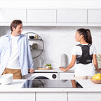 Two people in a kitchen with one wearing a black back brace.