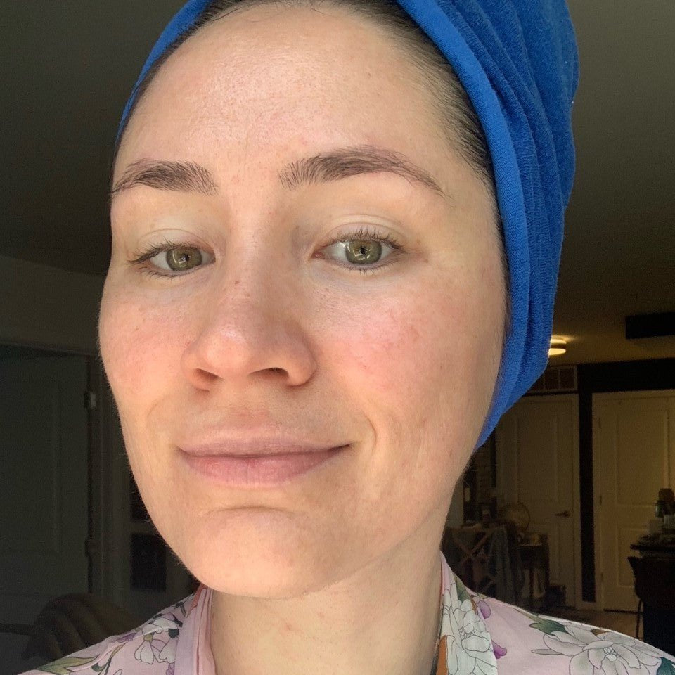 Person wearing a blue headscarf and floral pajama top indoors.