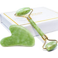 Green jade roller and gua sha tool with gold accents on a white background