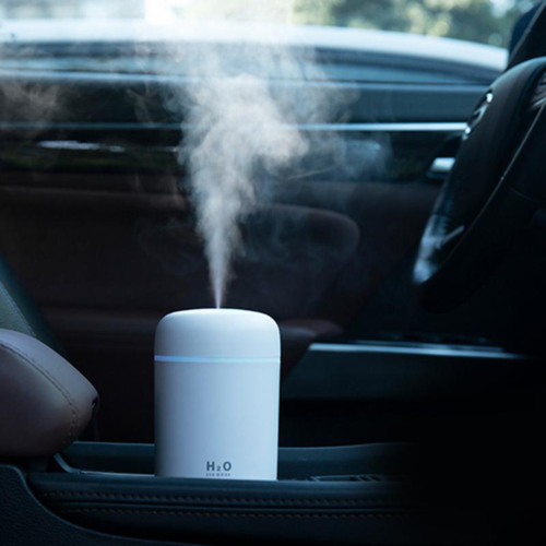 Car humidifier emitting steam inside a vehicle
