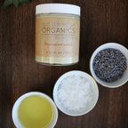 Butter Me Up Organics magnesium lotion jar with ingredients on a wooden surface