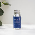 White Rabbit skincare bottle with blue label on a white surface