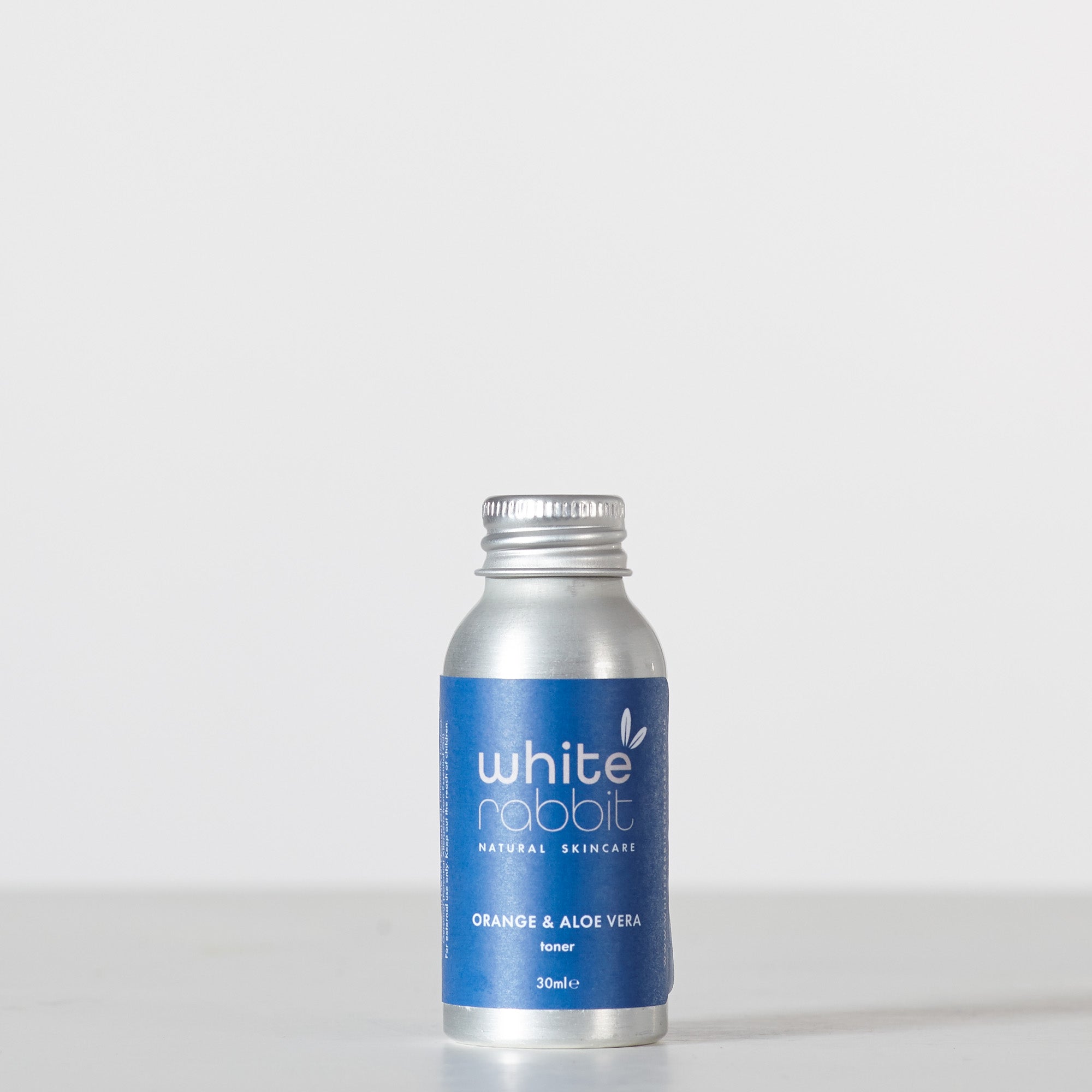 Silver bottle with blue label on a white background