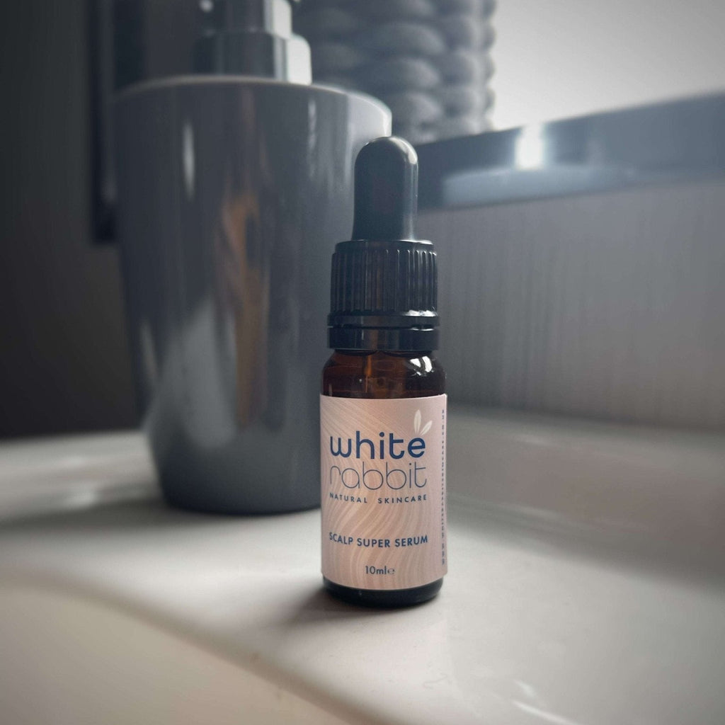 Bottle of 'White Rabbit' scalp serum on a bathroom counter