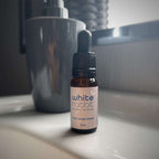 Bottle of 'White Rabbit' scalp serum on a bathroom counter