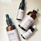 Four bottles of 'White Rabbit' scalp serum on a white background