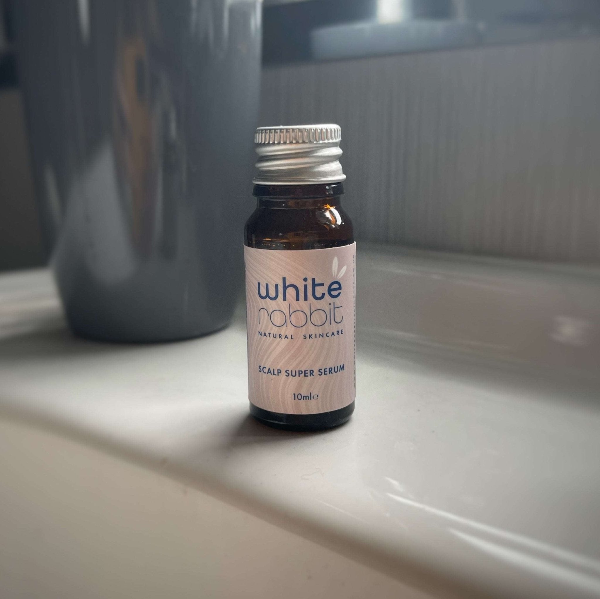 White Rabbit Scalp Super Serum bottle on a bathroom counter